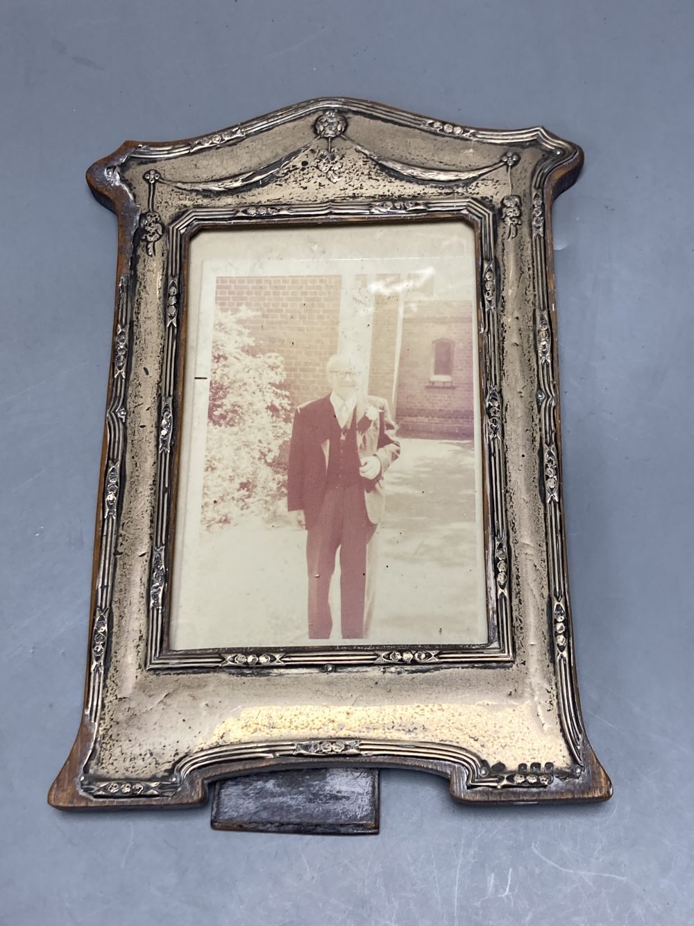 An Edwardian silver mounted photograph frame, Birmingham, 1906, 22.2cm(a.f.) and two others.